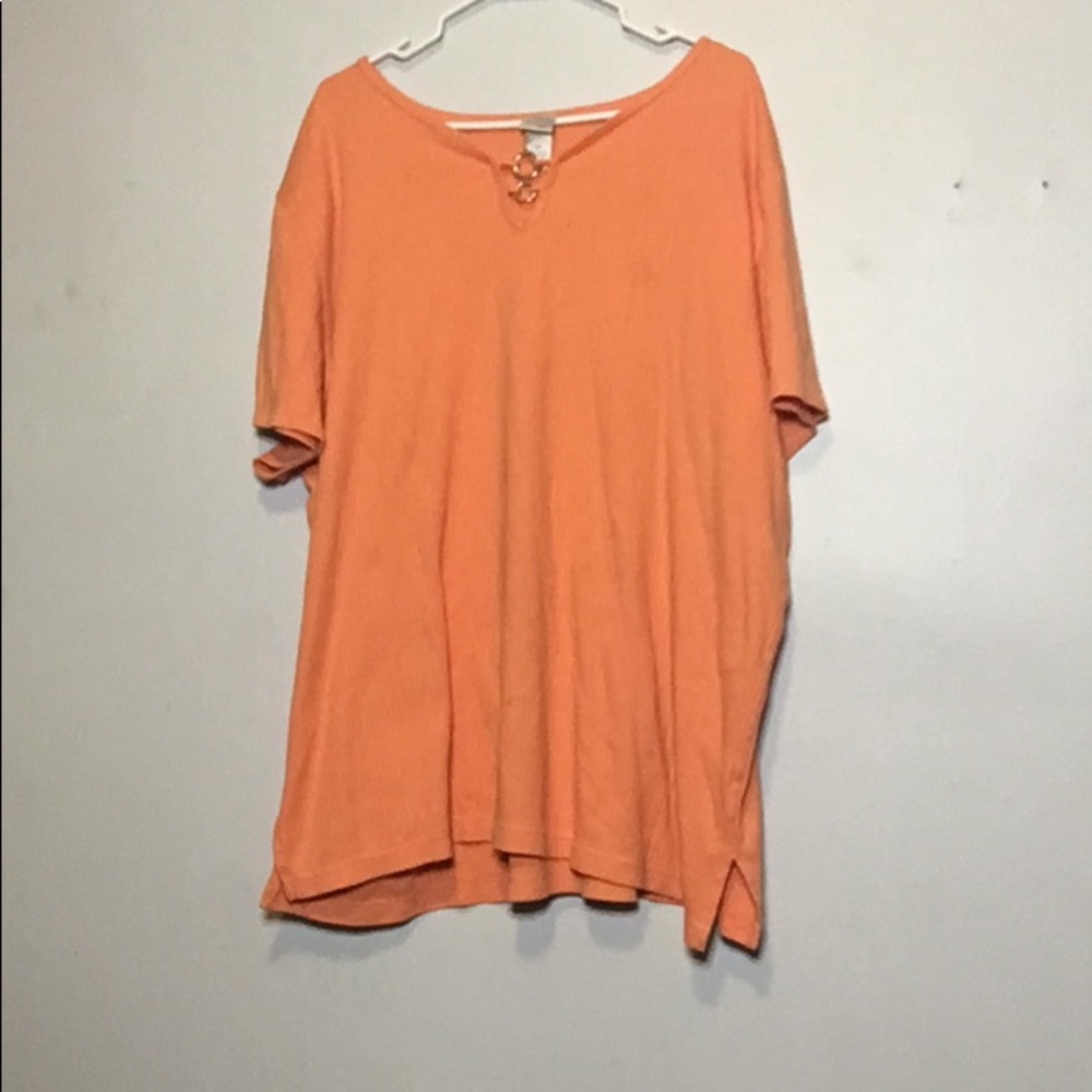 This is a peach shirt with a two golden rings